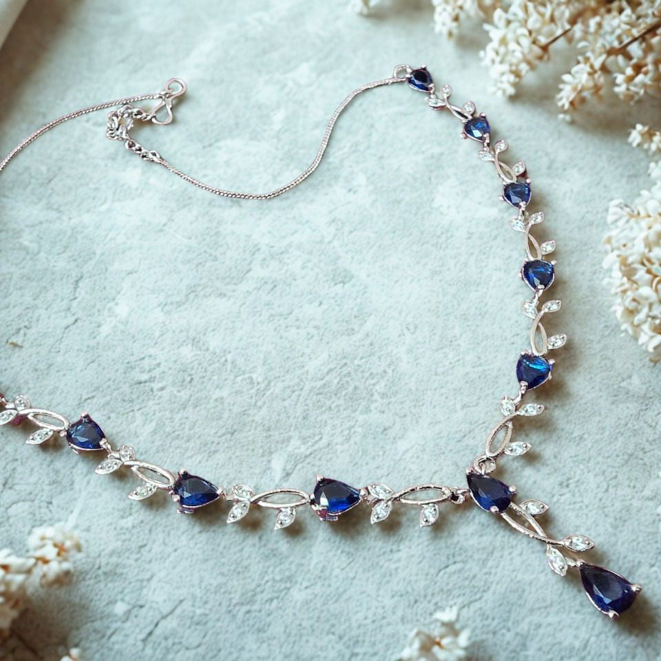 Silver necklace with blue stones on a light background