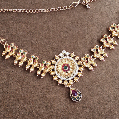 Decorative necklace with gold and gemstone details on a brown background