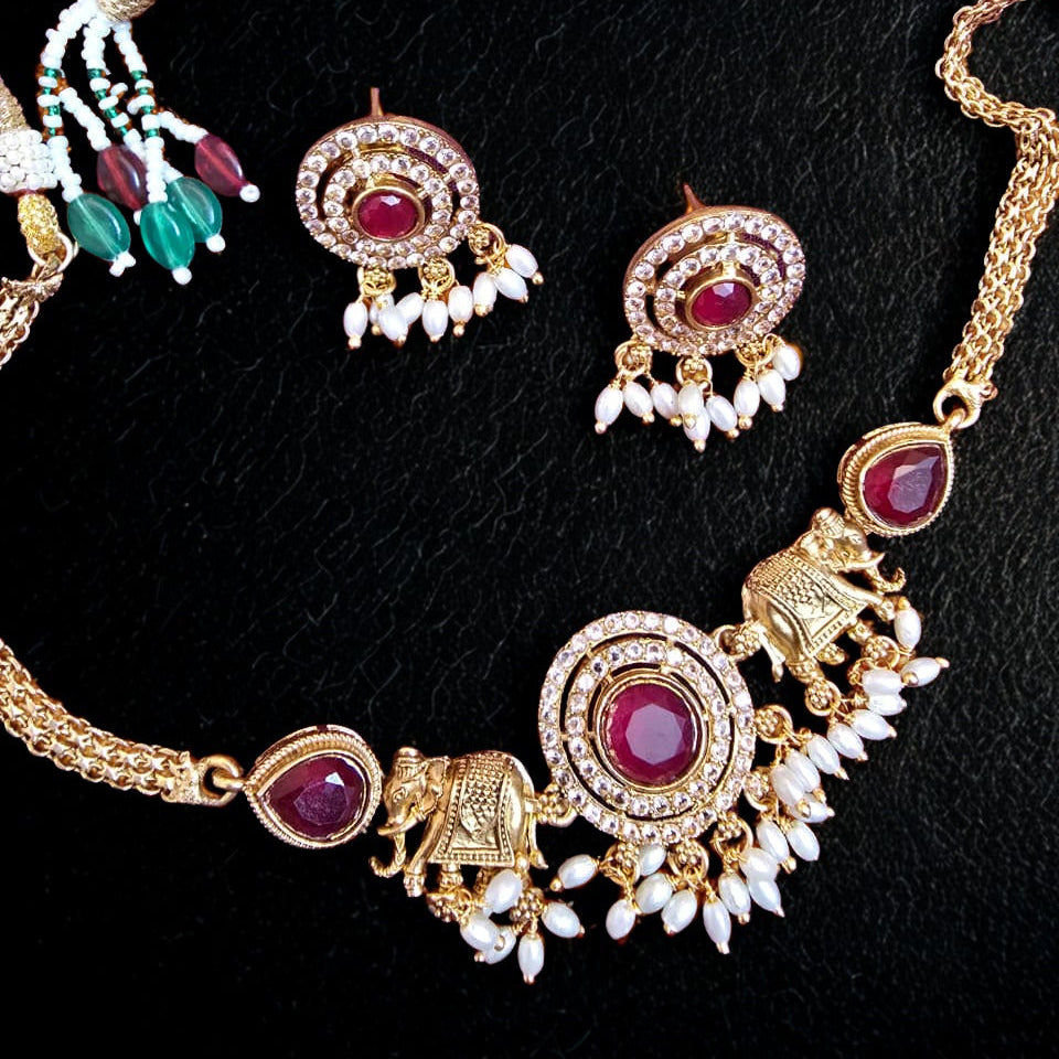 Temple elephant motif kundan necklace set with ruby stones and pearl drops with matching earrings