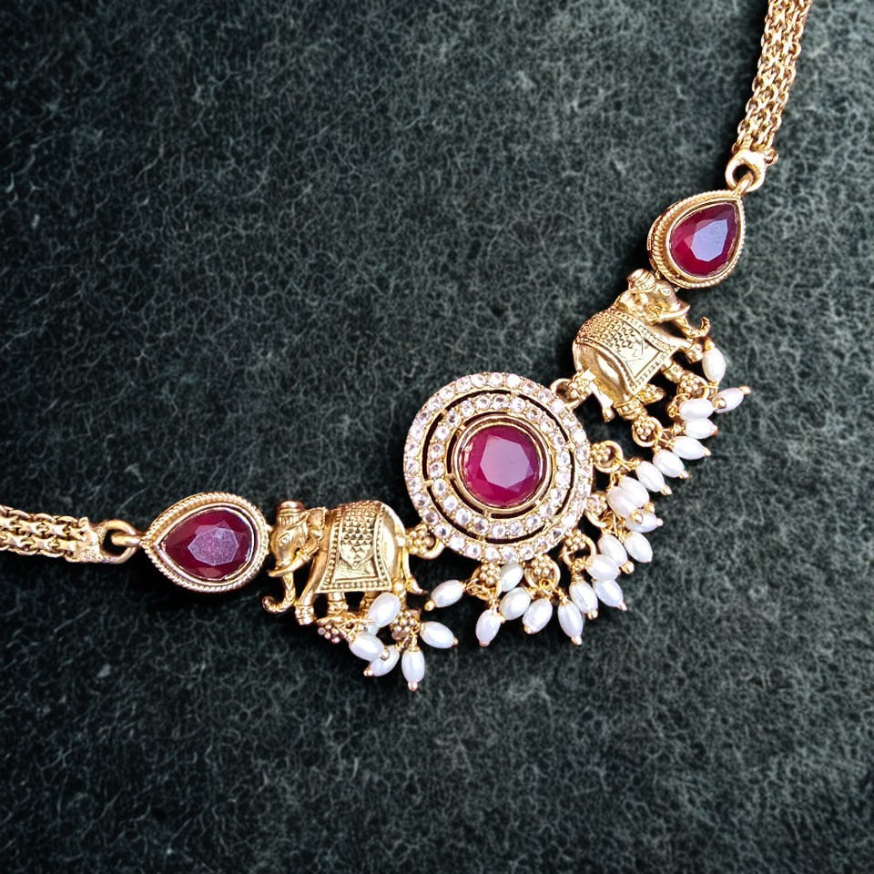 Temple elephant motif kundan necklace set with ruby stones and pearl drops with matching earrings