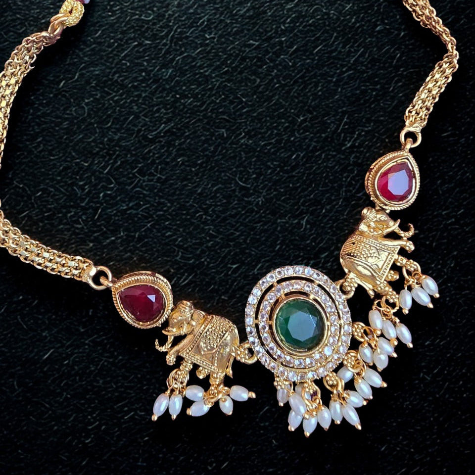 Temple elephant motif kundan necklace set with ruby stones and pearl drops with matching earrings